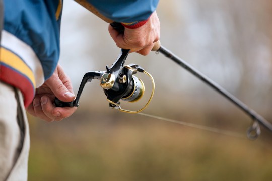 bigstock-Fisherman-s-Hands-With-Spinnin-52970047