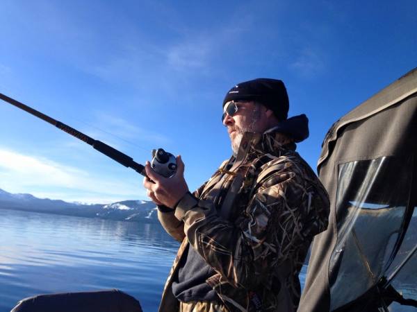 Hank Shaw catching lake trout. Image by Randy King.