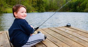 bigstock-Boy-smiles-while-fishing-from—18537422