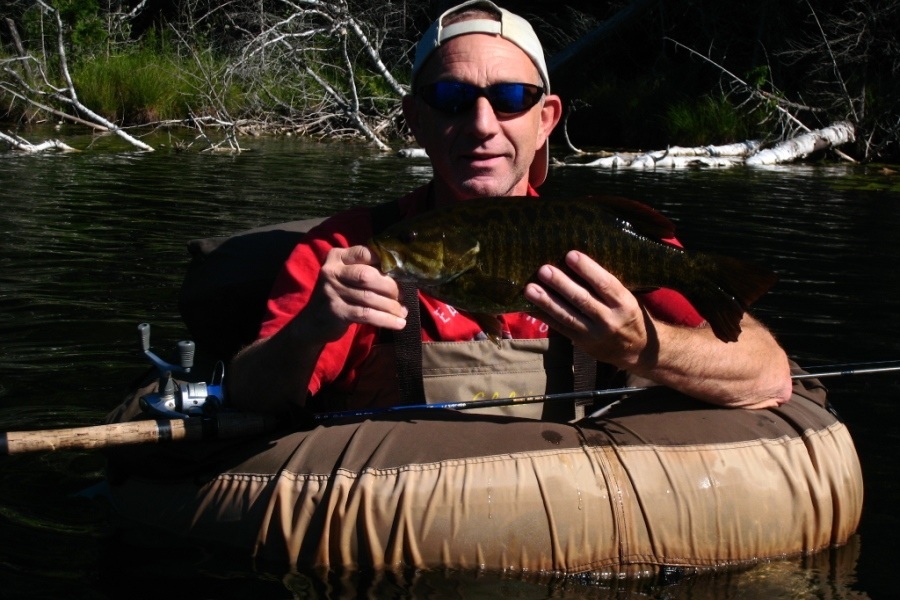 Angler inside a fishing float holding a fresh catch