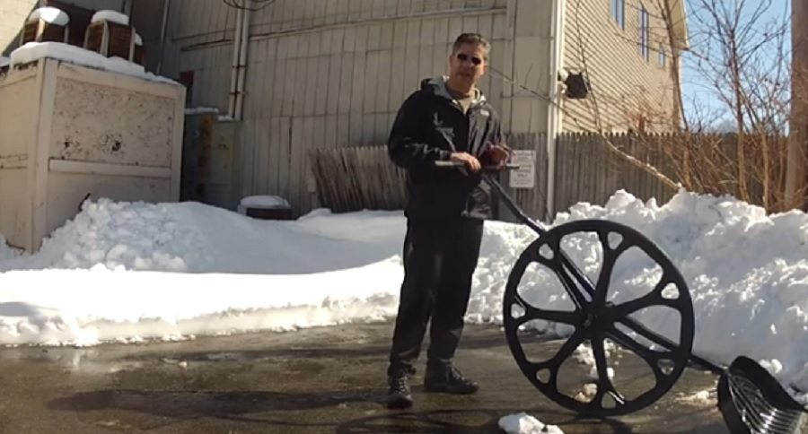 snow shovel with a wheel on it