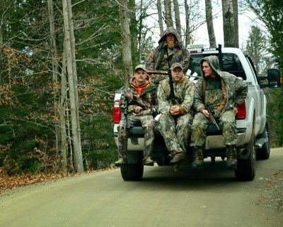 new york outdoorsman hunters riding back of pick up truck