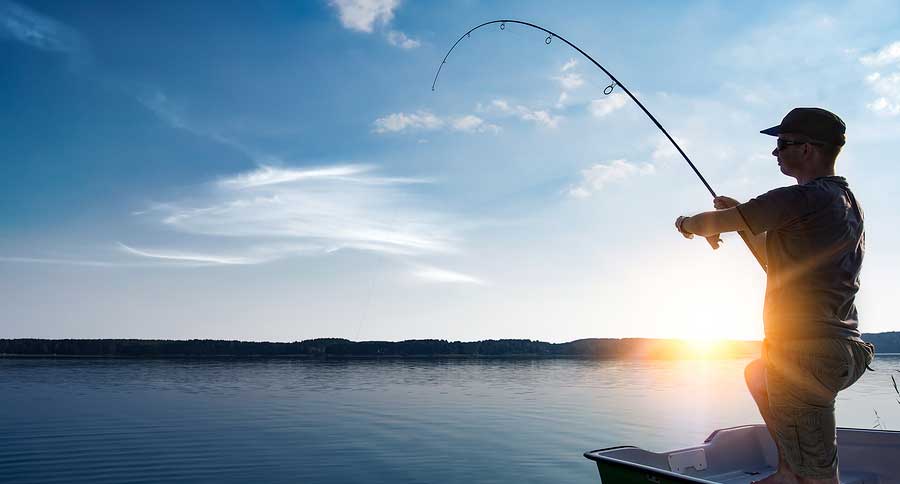 man fishing from boat