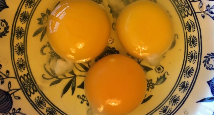 orange yolk healthy pasture-raised egg and two supermarket eggs