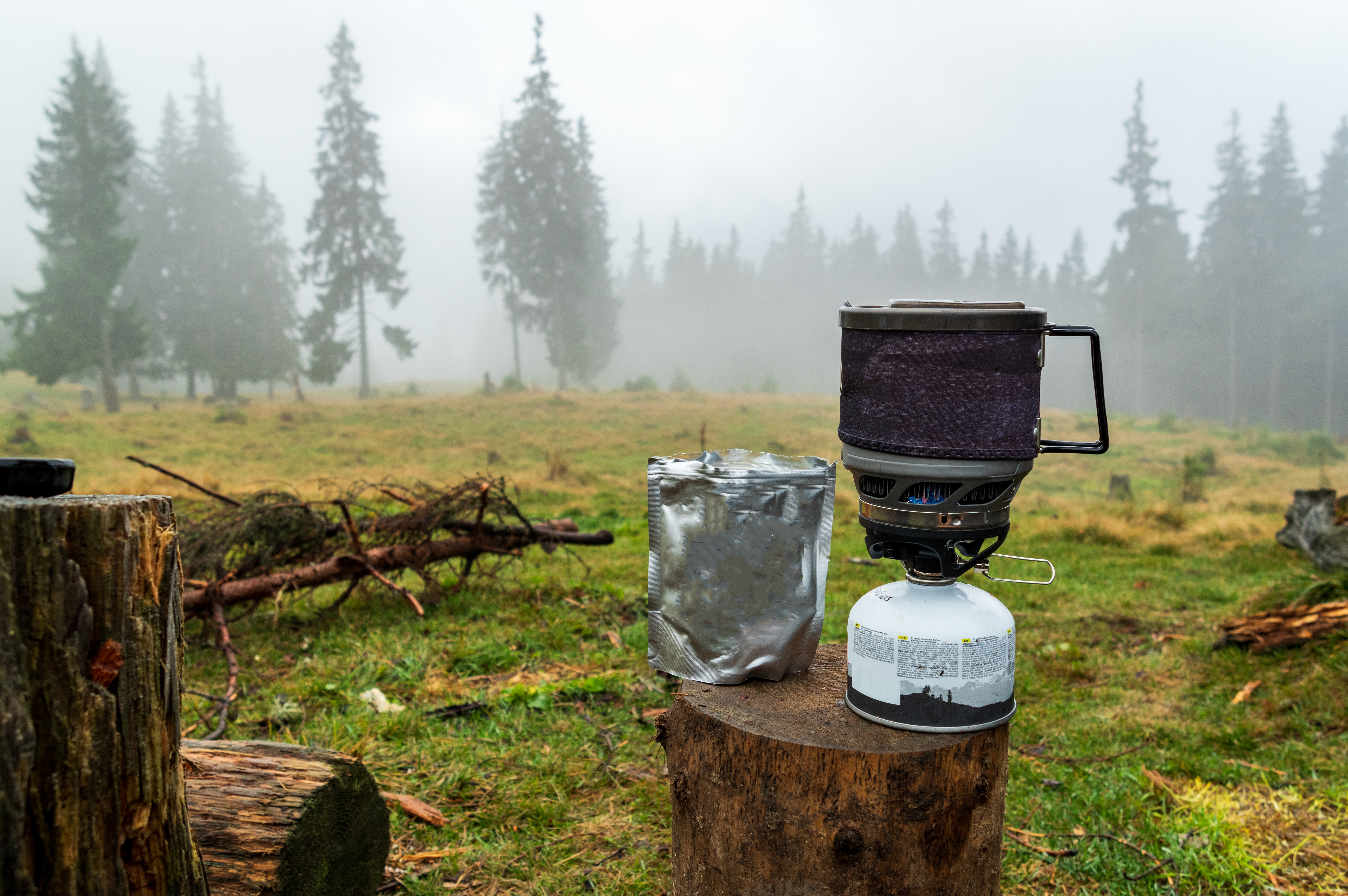 Cooking in the forest. Freeze-dried food in a package. Dried food and gas stove. Breakfast in the forest. Food in a package.