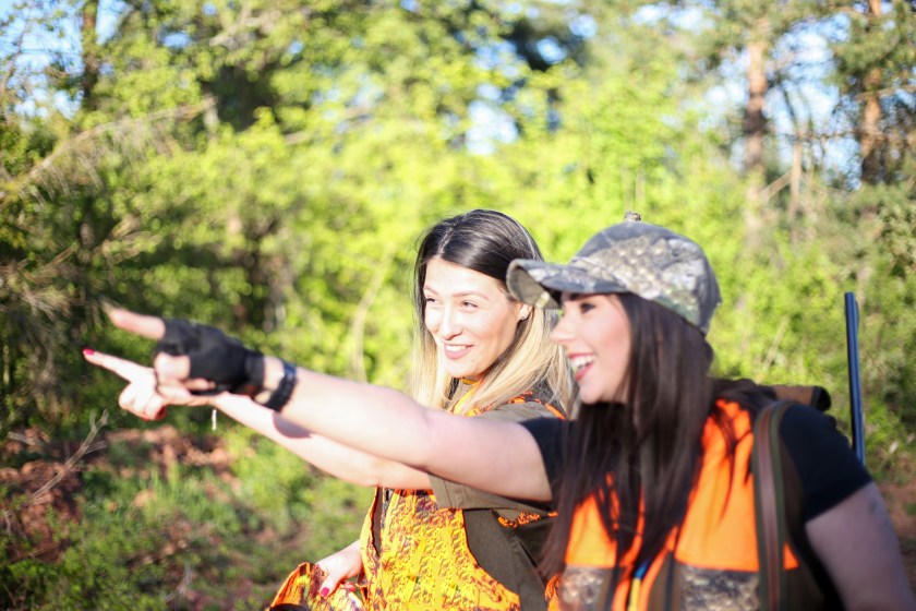 Hunters aiming to birds, hunting in woods