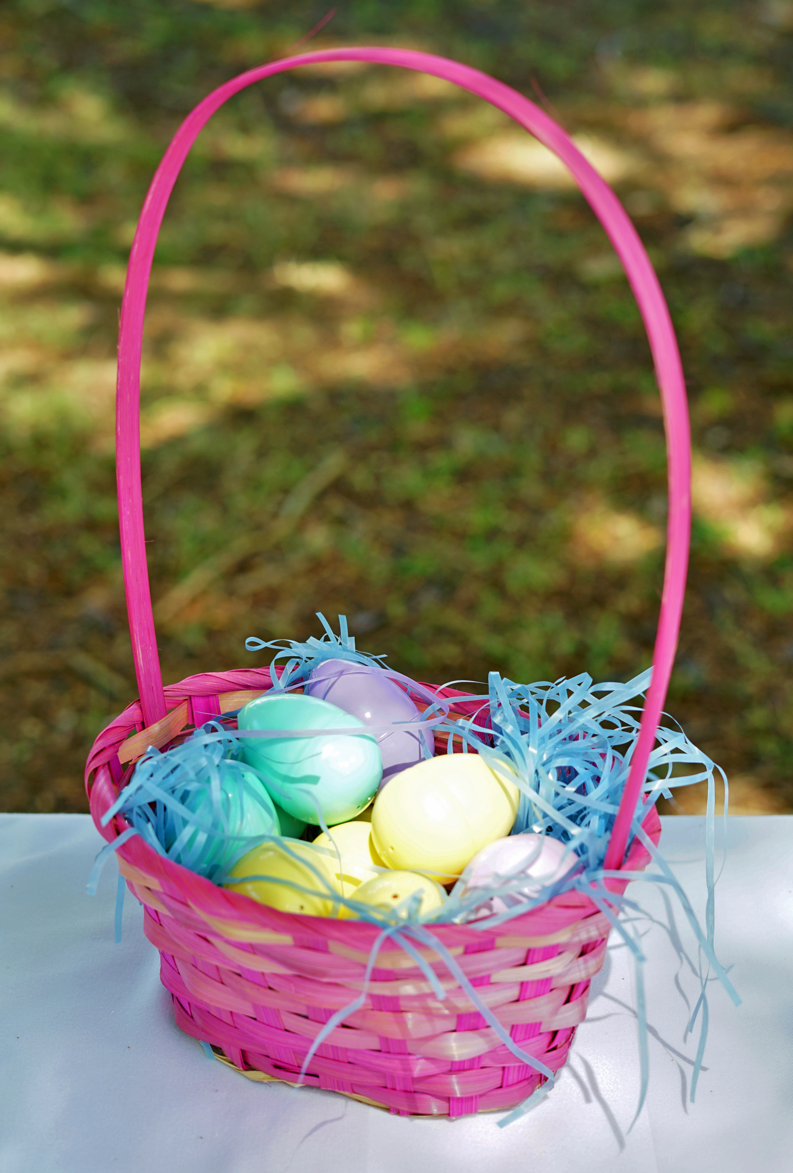 Colorful pink wicker baskets filled with Easter eggs