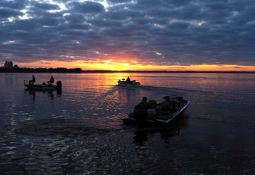 Bass anglers on a Florida lake leave at sunrise