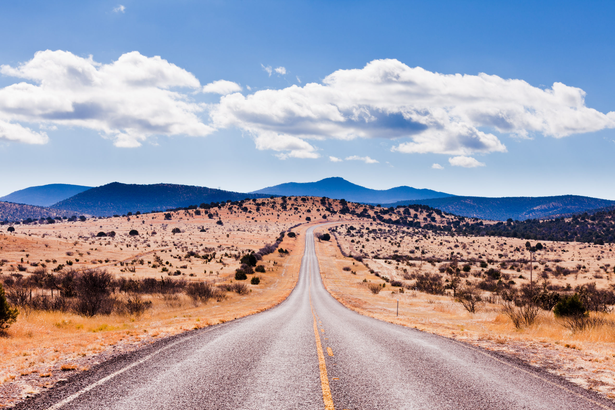 Straight road to horizon in high desert landscape of Davis Mountains, Texas, US