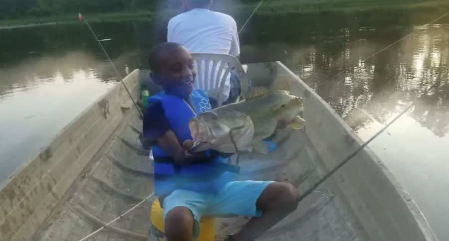 kid catching bass