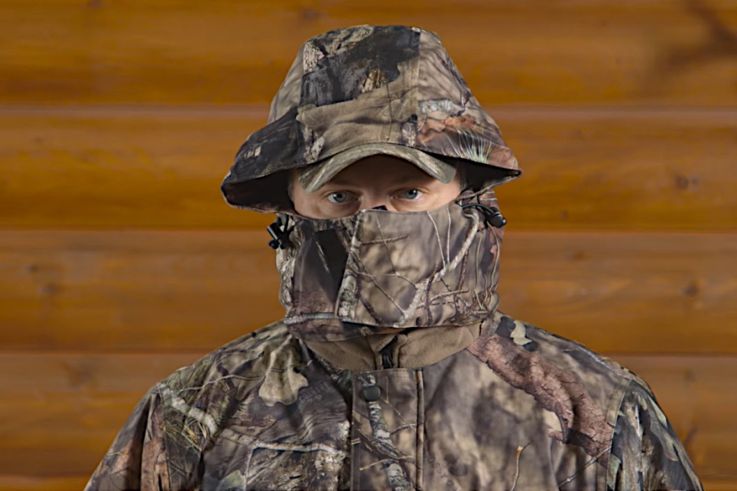 A hunter demonstrating the use of hunting coveralls