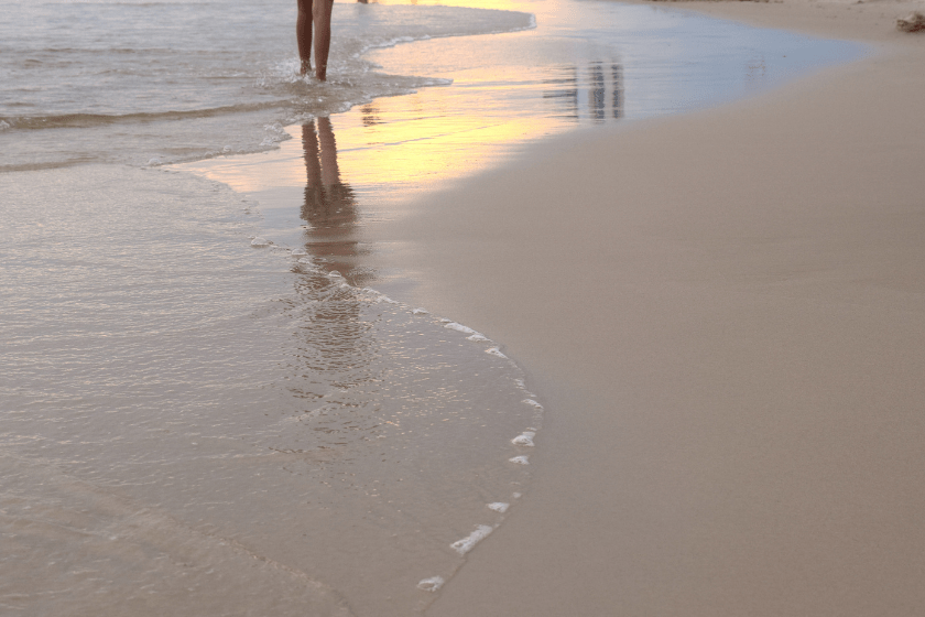 Taking an afternoon stroll along this calm beach. Enjoying the warmth of the ocean.