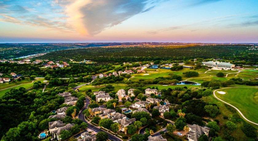 sunset above the Texas hill Country West Lake view of the hills near the lake at Sunset with a colorful horizon and mansions and luxury homes below