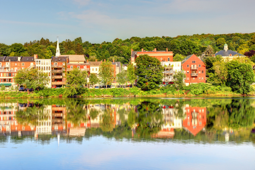 a city is reflected in the water of a nearby river