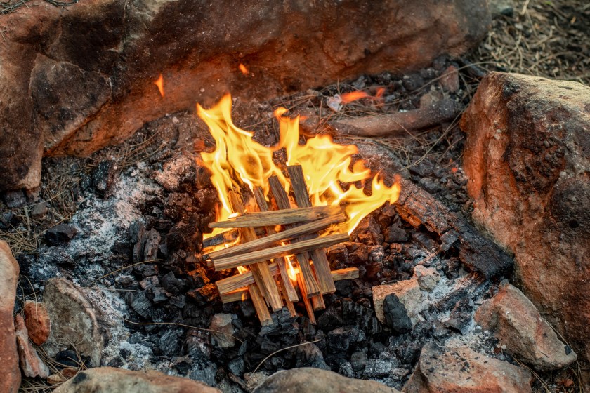 Starting the camp fire with kindling. Camping life