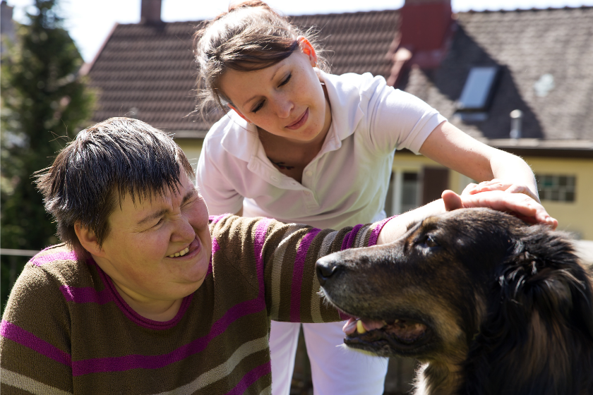 young man pets dog