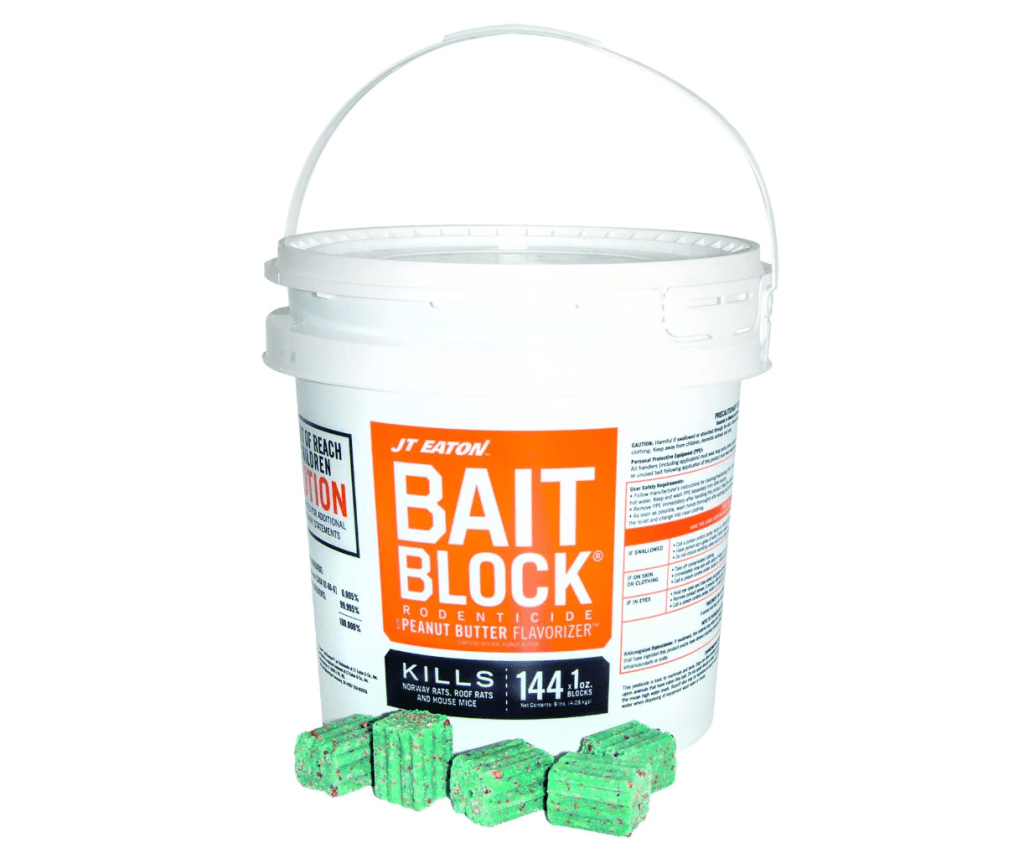 A large, white, plastic bucket filled with green rat bait