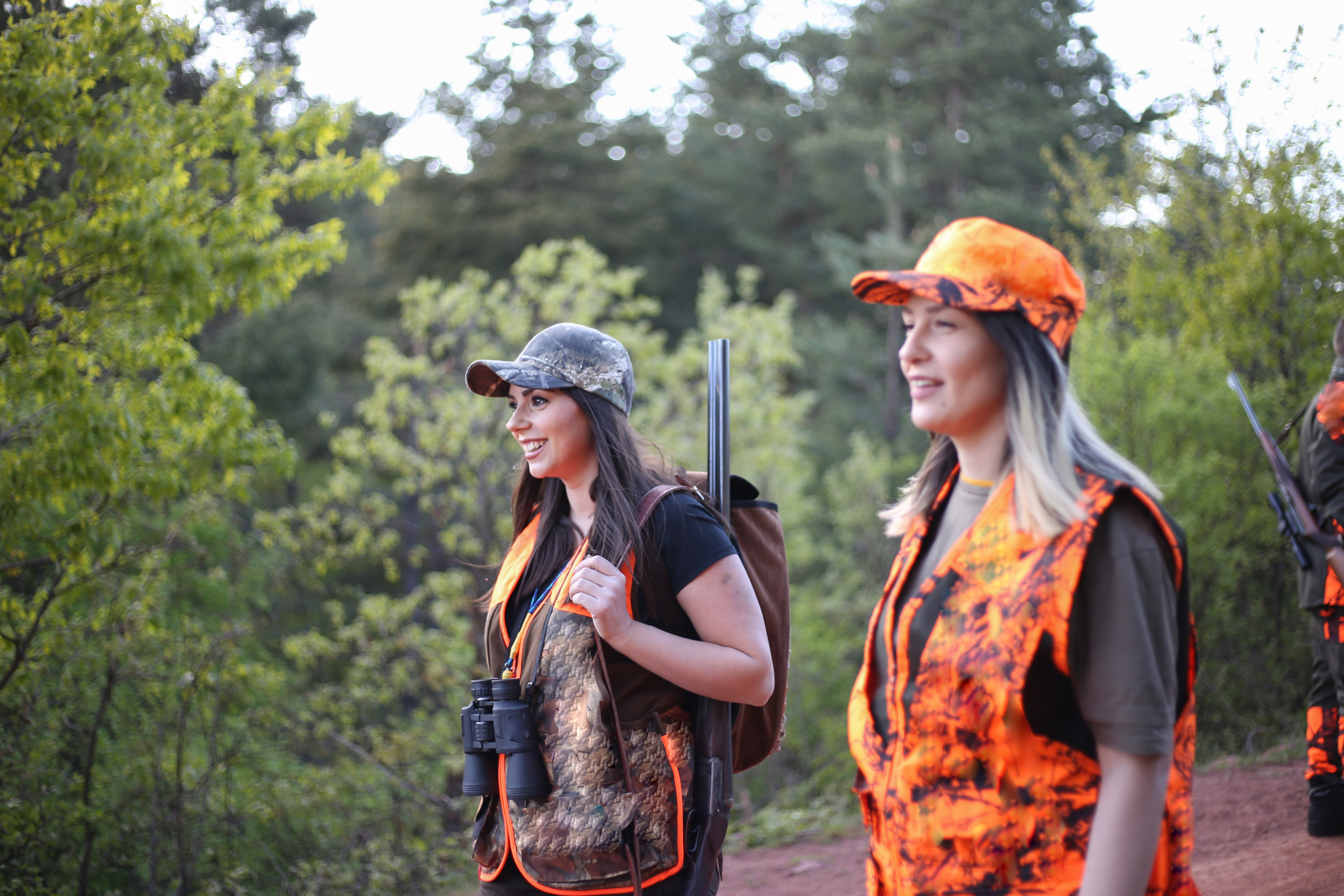 Hunters aiming to birds, hunting in woods.