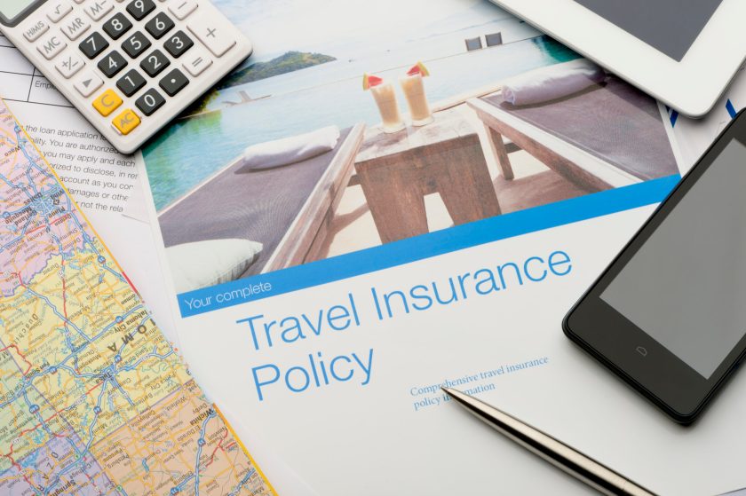 Travel insurance policy document with paperwork and technology