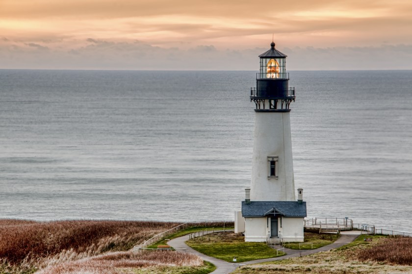 HDR photo of the Yaquina Head Lighthouse in the town of Newport Oregon. It is one of many lighthouses seen along the Oregon Coast. This lighthouse is still in operation today. The rotating light is seen in this image.