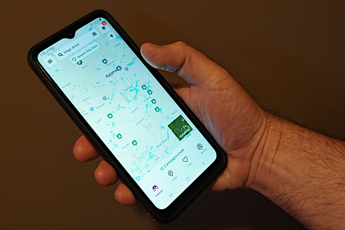 A cell phone looking at a camping app.