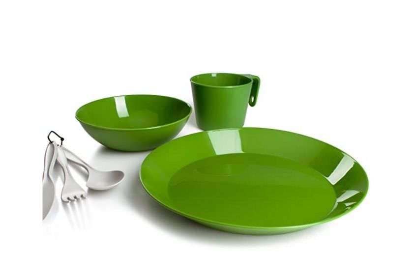 green camping dishes for one person (one plate, bowl, coffee mug, and fork and spoon)