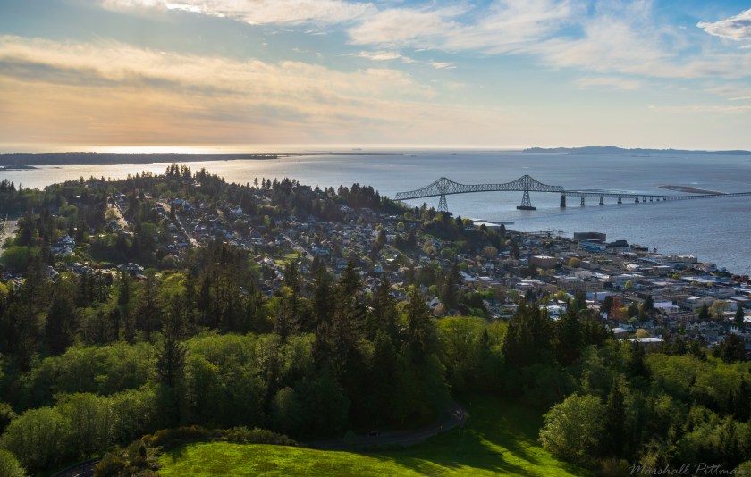 A view of downtown Astoria, Oregon from the Astoria Column above town. The Astoria Megler Bridge connects Oregon to Washington over the Columbia River.