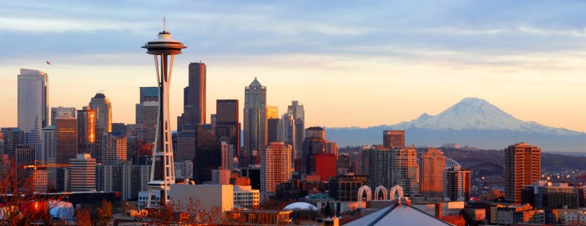 Panorama of downtown Seattle and Mt. Rainier at sunset.