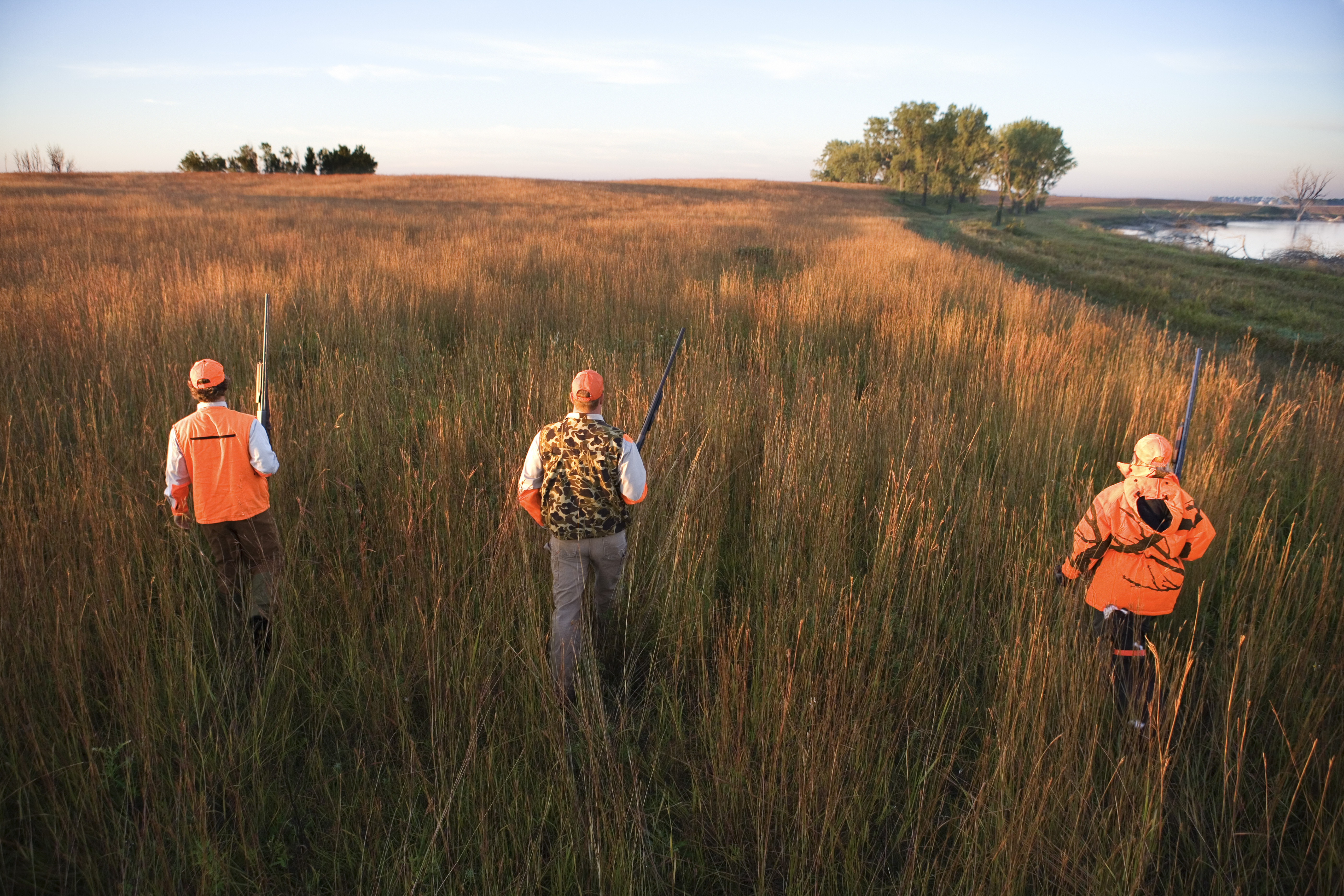 dove hunters walking through field
