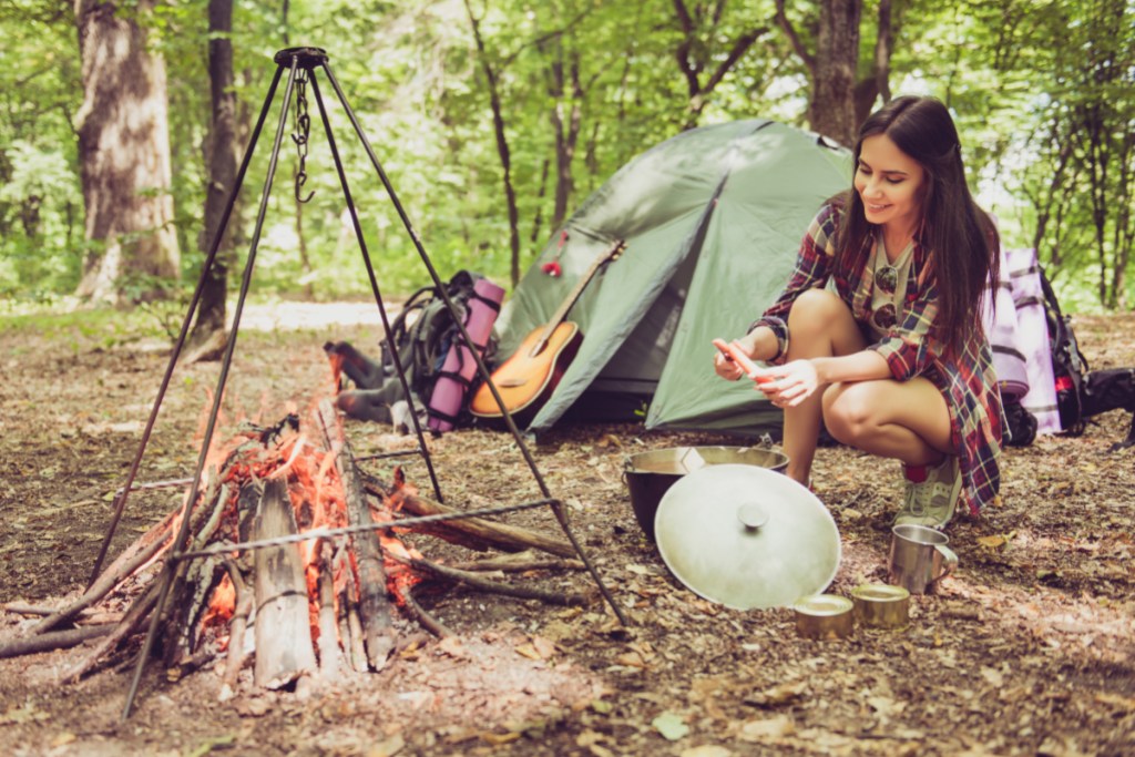 A woman cooking at her campsite.