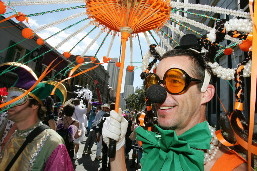 Mardi Gras revelers marching in the Society of St. Anne parade in New Orleans.