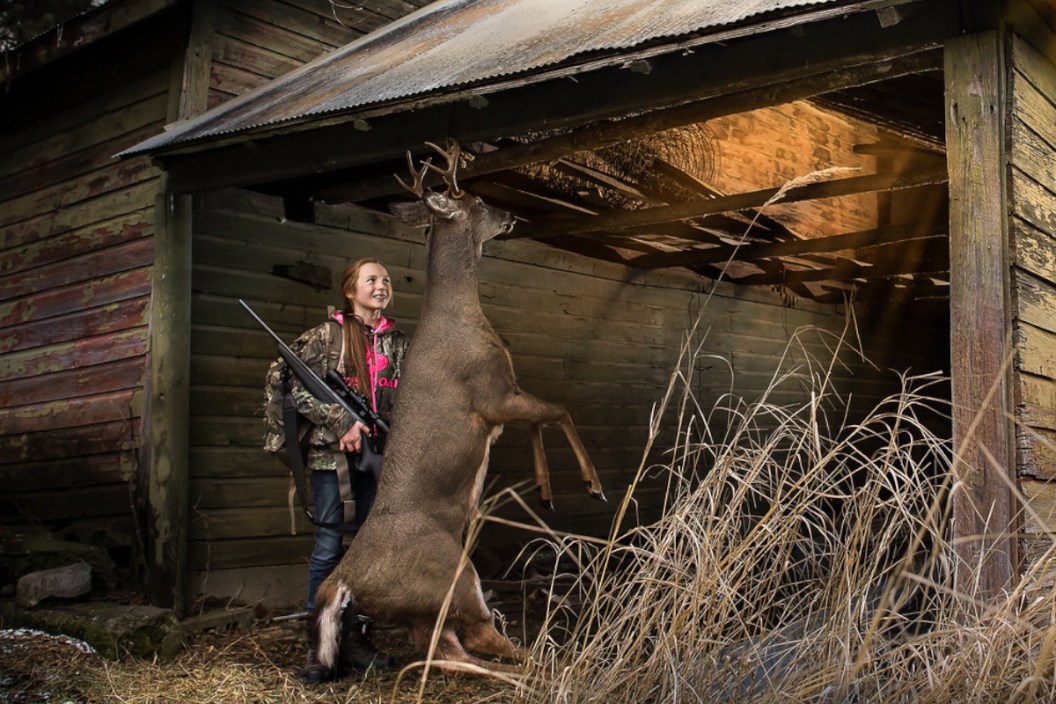 A young female hunter with her buck.