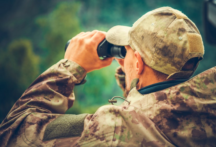 Caucasian Hunter Spotting Game Using Binoculars
