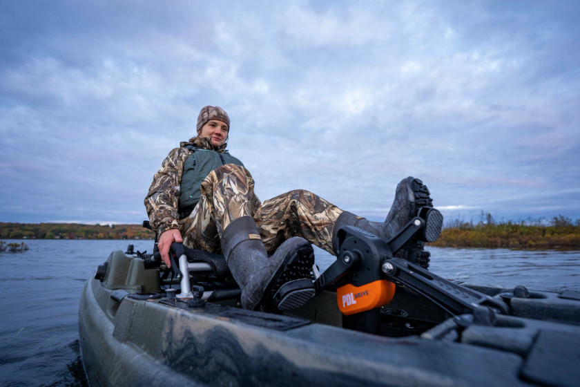 A hunter pedaling a kayak to the next hunting spot. 