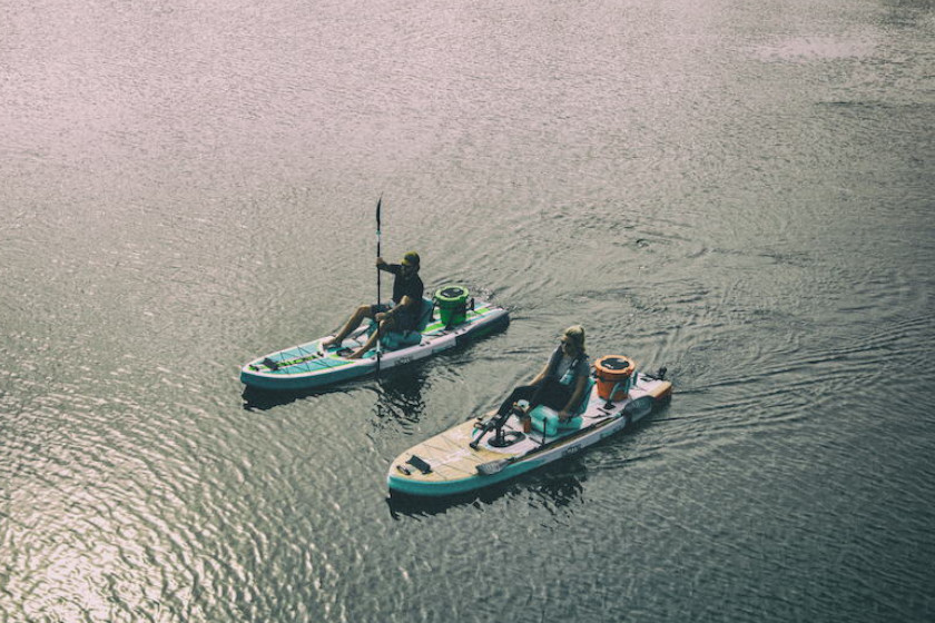Two stand-up fishing paddleboards with pedal drive systems.