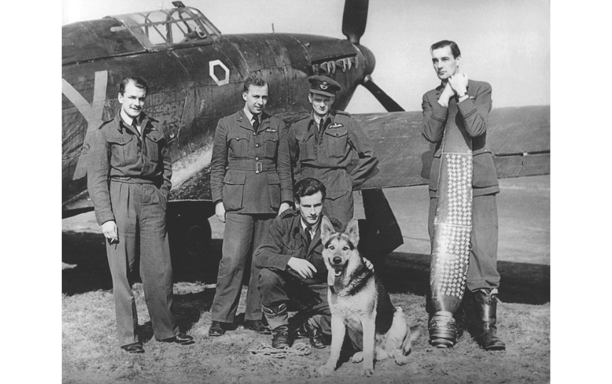 Portrait of British soldiers posing with their German Shepherd, 1941