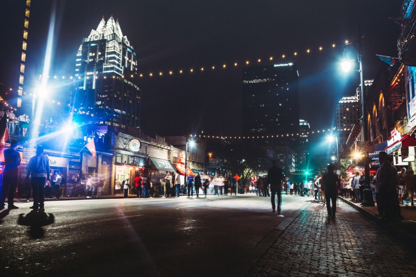 Weekends finds Austin, Texas 6th Avenue closed to cars, allowing foot traffic to easily come and go from the city nightlife, bars, and clubs. Horizontal, long exposure image.