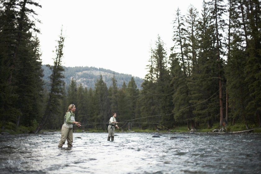 Two women fly-fishing in Gallatin river in Montana