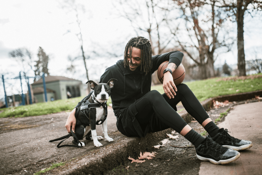 man relaxes with dog in Portland Oregon