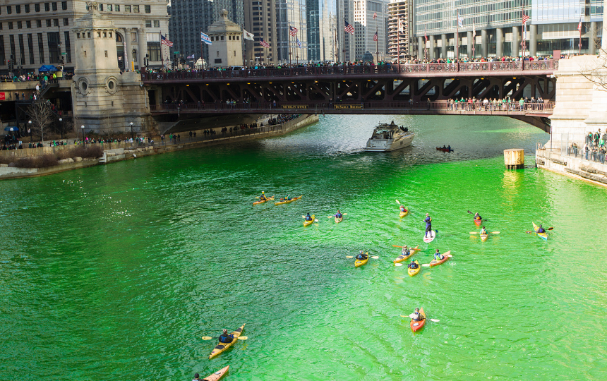 Kayakers paddle along a bright-green river during the annual dying of the Chicago River for St. Patrick's Day celebrations. 3/14/2015