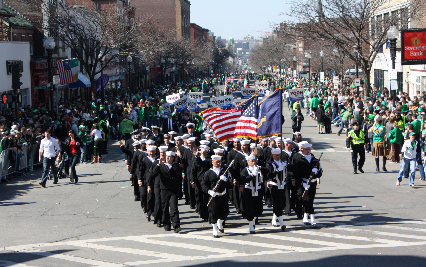 A crowd along a parade route in South Boston cheers Sailors from the guided-missile frigate USS Taylor (FFG 50) as they march in the 108th Annual St. Patrick's Day Parade celebrating Boston's Irish heritage.