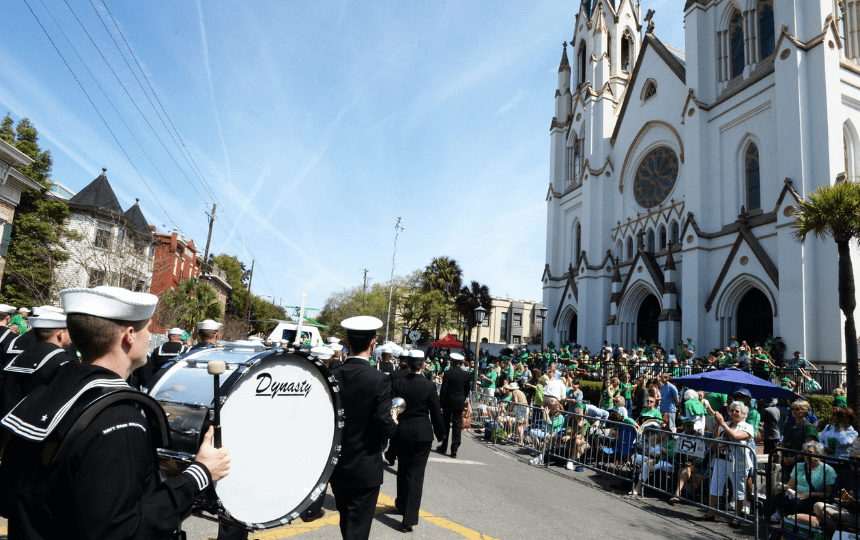 army members march in front of a church during a parade