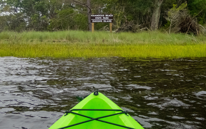 Kayaking at Huggins Island, Hammocks Beach State Park, North Carolina sign on the coastal waters