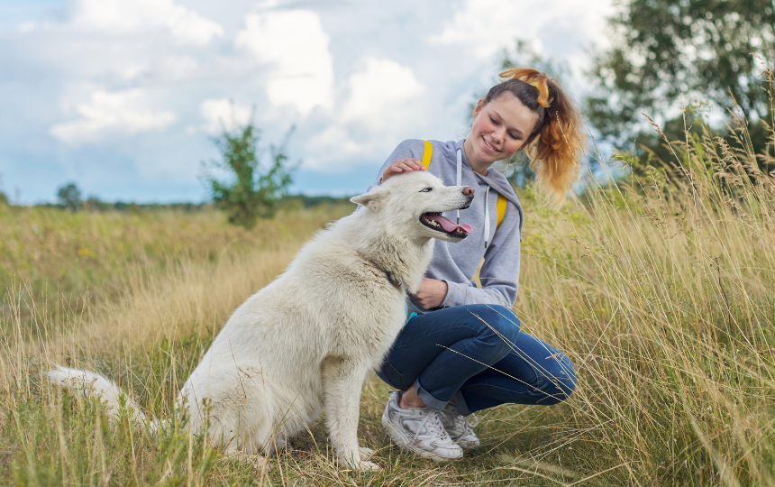 teenager sits with dog