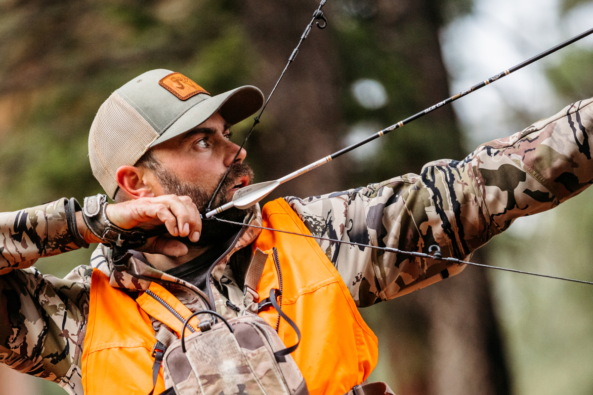 Remi Warren preparing to shoot his bow.