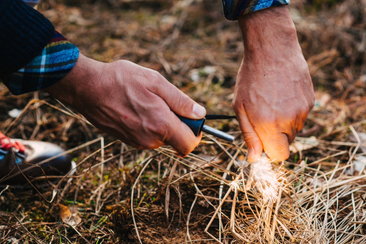 A camper starting a fire.