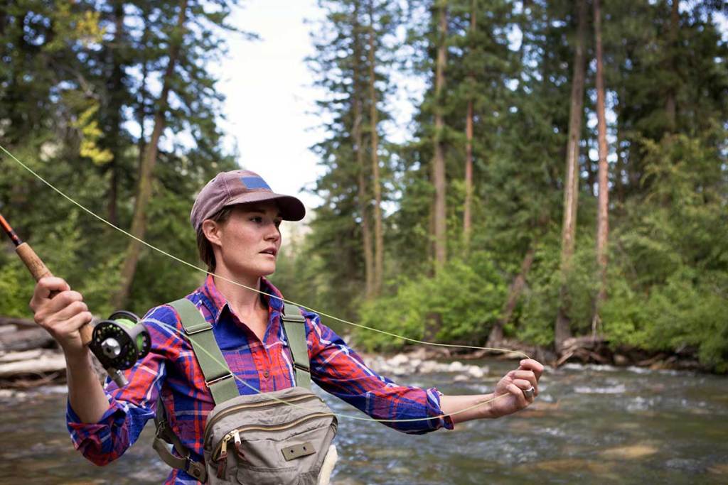 Woman Fly Fishing On A River