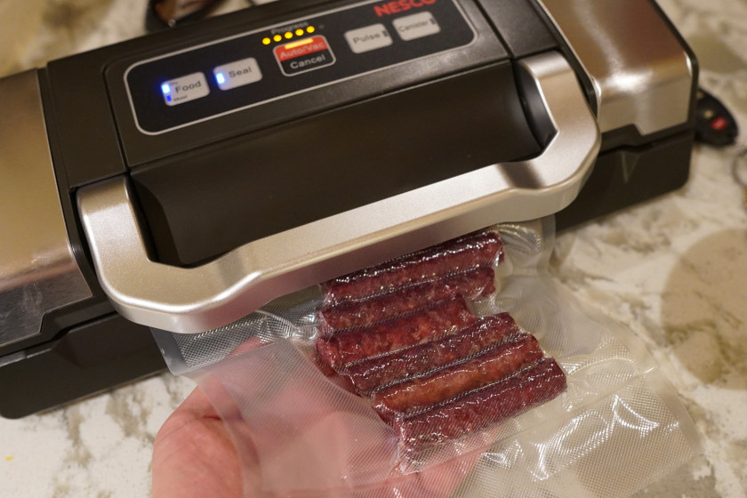 Vacuum sealing venison snack sticks.