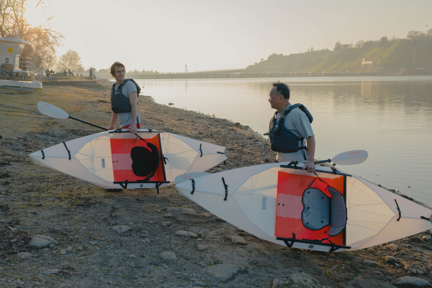 Two paddles carrying the Oru Kayak Lake.