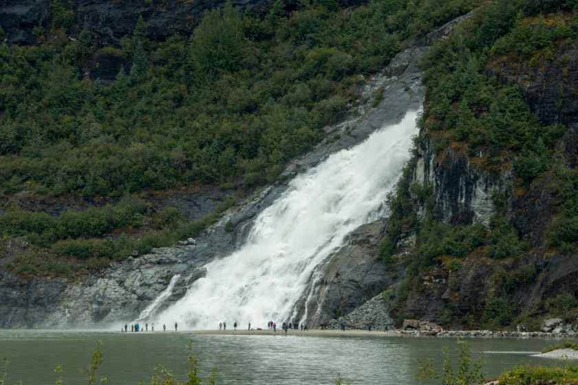 ALASKA, UNITED STATES - People at the Nugget Falls waterfall at the Mendenhall Glacier, near Juneau, Alaska, USA